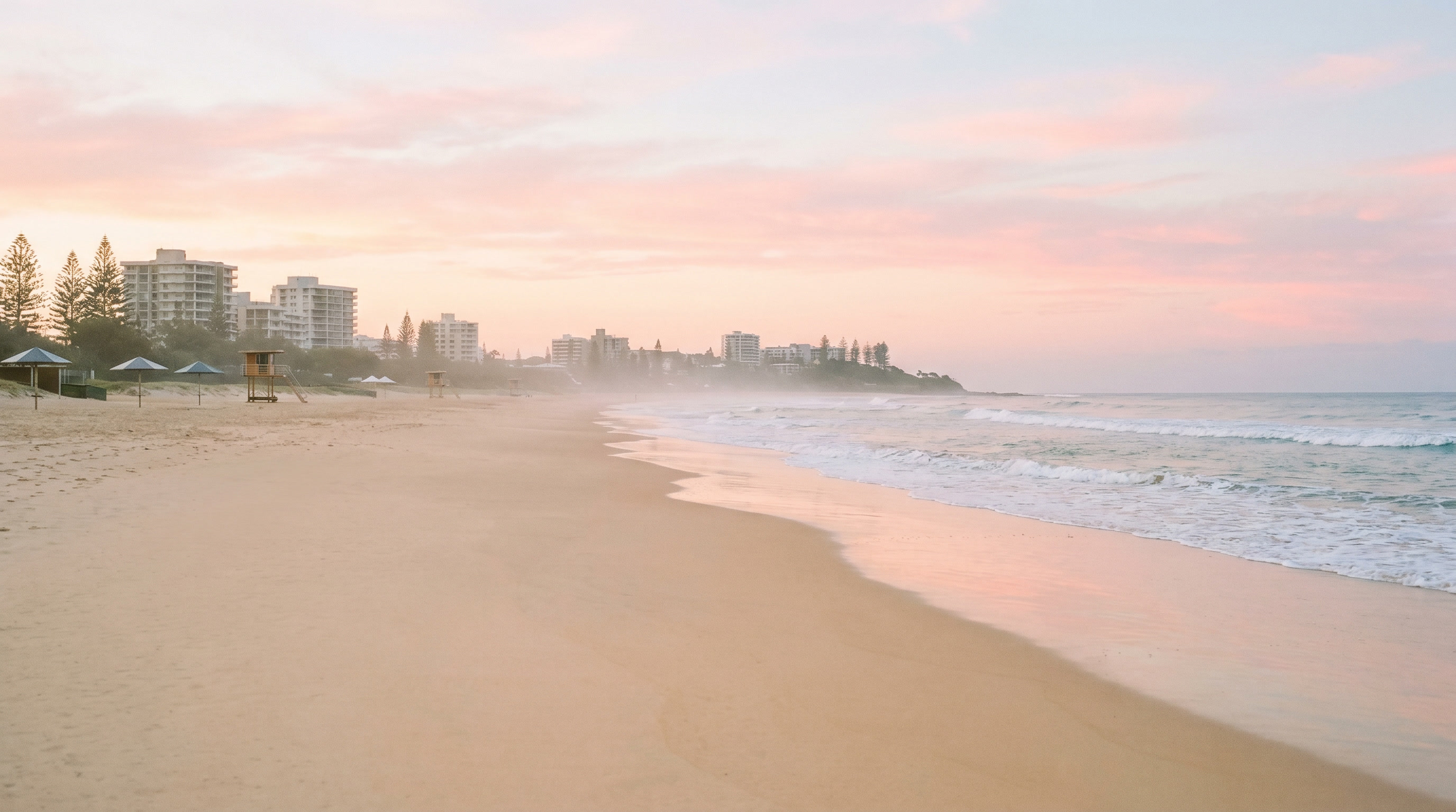 Alexandra Headland beach with pandanus, rocks, sand and morning surf.