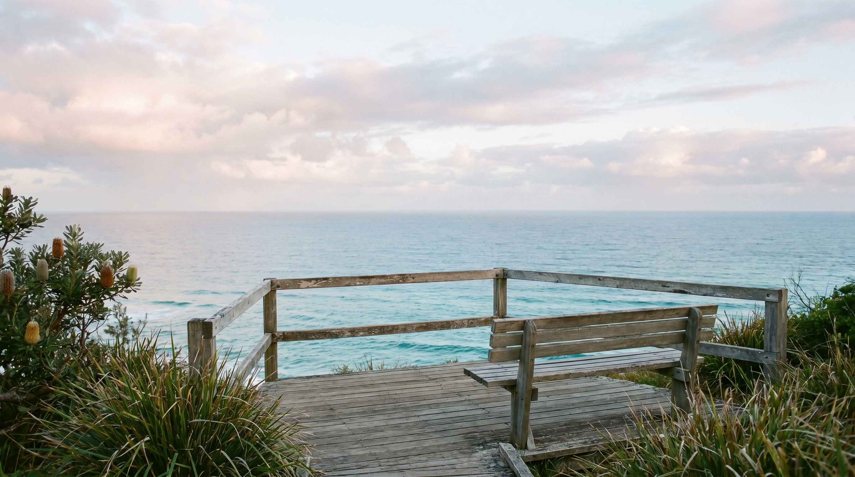 A quiet Sunshine Coast lookout view with ocean, sky and coastal vegetation.